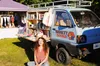 Creator Ariel Bissett posing in front of her blue book mobile